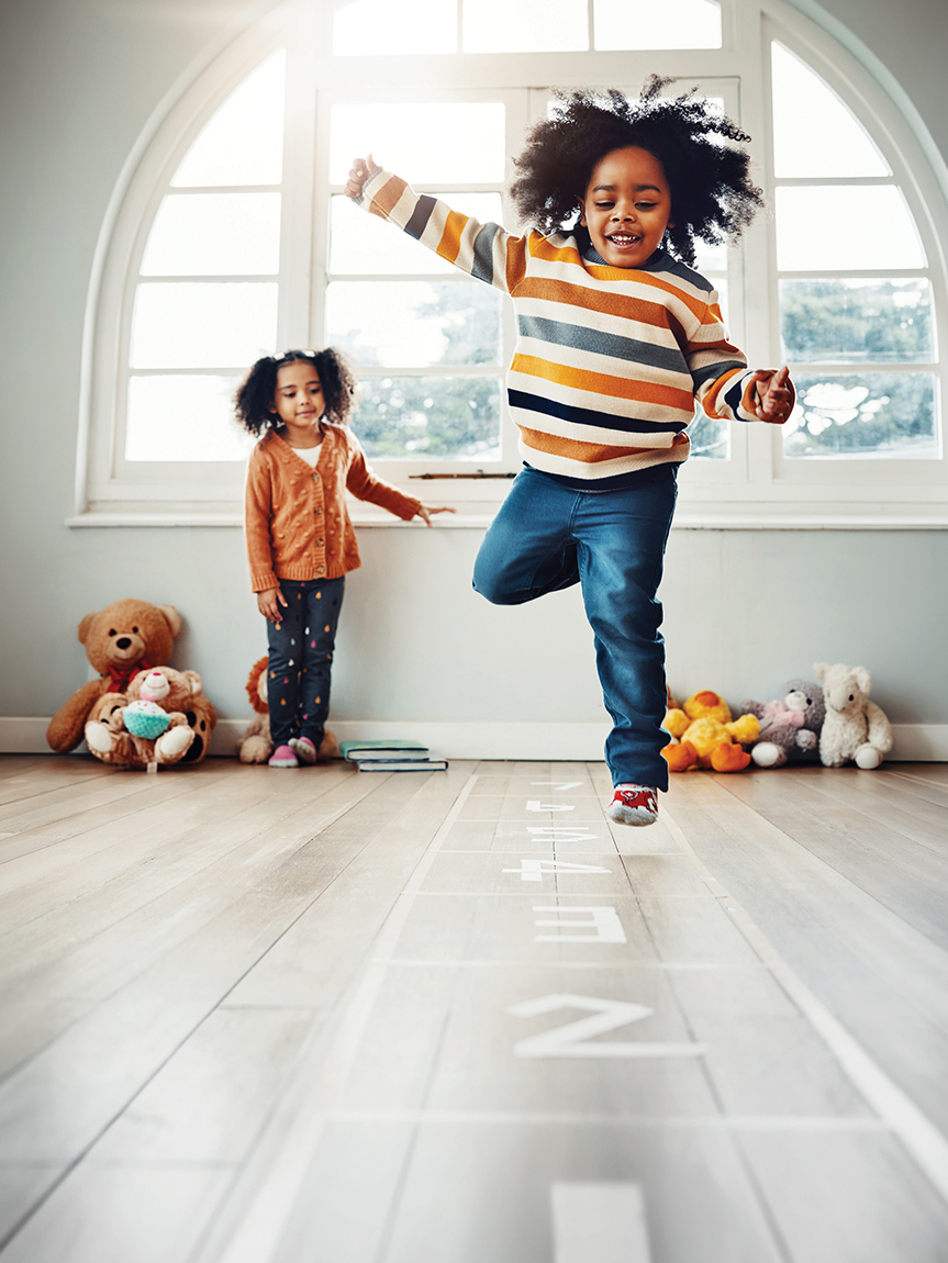 Family playing games in a living room with a hardwood floor